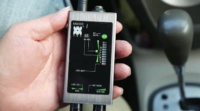 A broadband RF detector being used inside a vehicle cabin